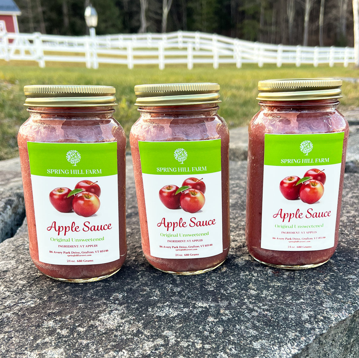 three mason jars of classic unsweetened apple sauce.